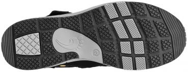 The image shows the sole of a shoe. It is predominantly black with a grippy tread. Some areas are light gray and textured, featuring various non-slip patterns.