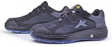 The image displays a pair of athletic shoes in black and gray with a non-slip sole and breathable material. They feature a modern, lightweight design and lacing.