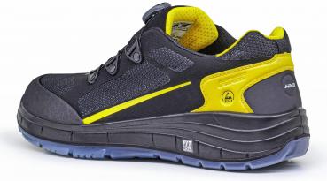 The shoe is black with yellow accents. It has a sporty shape, a thick, textured sole, and a padded insole. The laces are tight and secure.