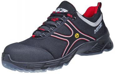 The shoe is a sporty safety workout shoe. It is predominantly black with red accents and a sturdy, non-slip sole. Laces ensure a secure fit.