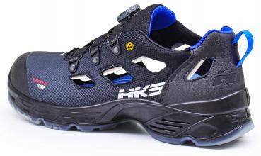 The shoe is a black sports shoe with blue accents. It features a breathable upper, side ventilation openings, and a non-slip sole for good grip.