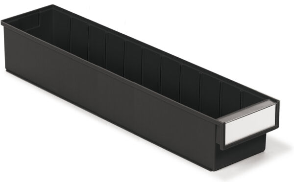 The image shows a long, black, rectangular container with multiple compartments. On one side, there is a small, white area, possibly for labeling.