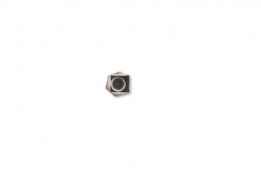 The image shows a hexagonal nut lying on a white background. The nut has a black recess in the center and appears to be made of metal.