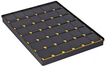 The image shows a rectangular, flat box with 24 small, square compartments arranged in a 4x6 pattern. The compartments are black, with yellow edges.