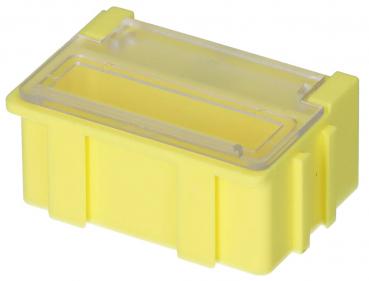 The image displays a small, yellow plastic box with a transparent lid. The box has a rectangular footprint and side reinforcements for stability.