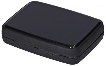 The image shows a rectangular, flat container in matte black. It has rounded corners and a smooth surface. The lid is narrow and opens easily.