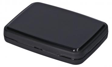 The image shows a rectangular, flat box in matte black. It has rounded corners and a smooth surface, appearing simple and inconspicuous. The box seems easy to open.