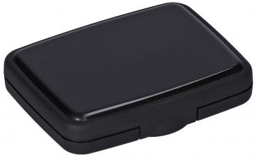 The image shows a rectangular, flat object in shiny black. It has rounded corners and a plain surface. The front features a slightly recessed area for opening.