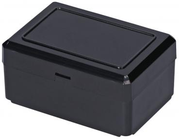 The image shows a rectangular, black box with a flat lid. The corners are rounded, and the top has a slightly raised area. It appears smooth and shiny.