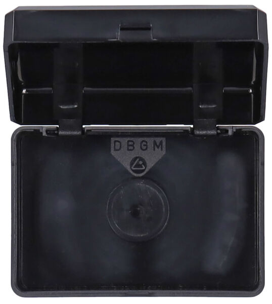 The image shows an open, rectangular black plastic container with a slightly curved bottom. Inside, there is a symbol and some flat surfaces.