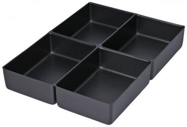 The image shows four rectangular, flat containers in matte black, closely packed together. They are uniformly shaped and have no handles or lids.