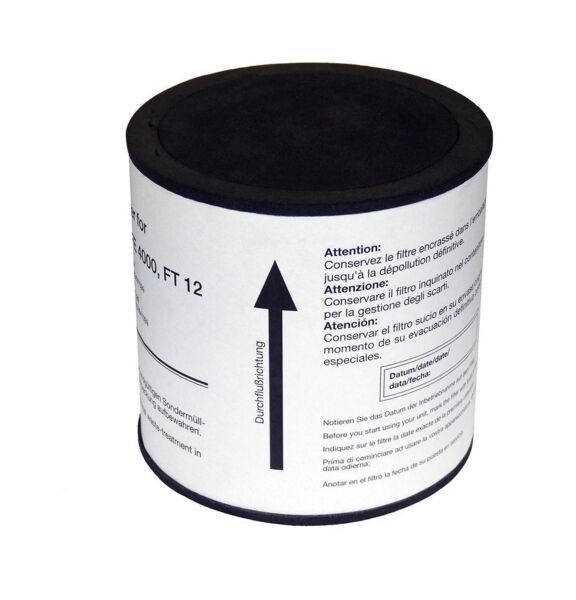 The image shows a cylindrical can with a black lid. The surface is printed with multilingual text and warning notices, including an upward arrow marking.