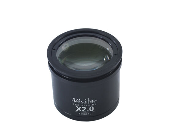 The image shows a cylindrical lens attachment in black. It has a smooth surface and a clear lens in the center, below which "X2.0" is indicated as a reference to the magnification.