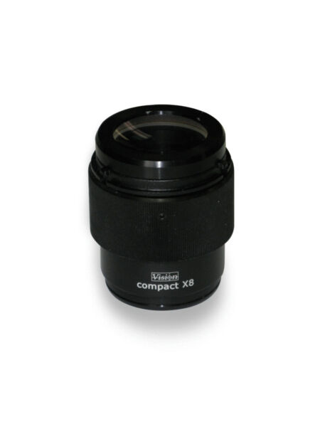 The image shows a black, cylindrical lens with a glass lens on top. It has a matte finish and features the inscription 