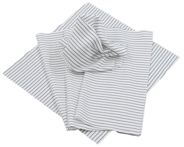 The image shows several white cloths decorated with fine, evenly distributed, vertical stripes in dark blue or black. The cloths are stacked on top of each other and are partially folded.