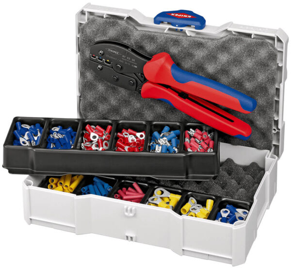 The image shows an open toolbox. Inside the toolbox, there is a crimping tool with red and blue handles, as well as several compartments with wire terminals in various colors: red, blue, yellow.