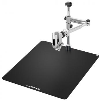 The image shows a black work surface with a metal bracket. The bracket is adjustable and has a clamp to secure objects.