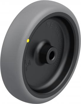 The image shows a gray wheel with a round, flat profile and a black core. On the outer side, there is a yellow dot. The wheel has a diameter of about 20 cm.