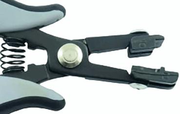 The image shows a black, ergonomically shaped pliers with gray handles. The pliers have a spring-loaded opening and two pointed gripping arms at the front, which can be moved together.