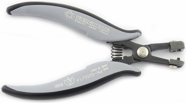 The image shows a pair of pliers with gray, rubberized handles. It has a spring in the hinge area and a sharp edge for cutting. It appears sturdy and ergonomic.