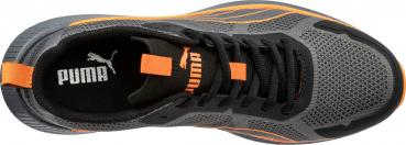 The image shows a sports shoe in gray with black and orange accents. The upper part is made of breathable material, and the laces are black. A Puma logo is visible.