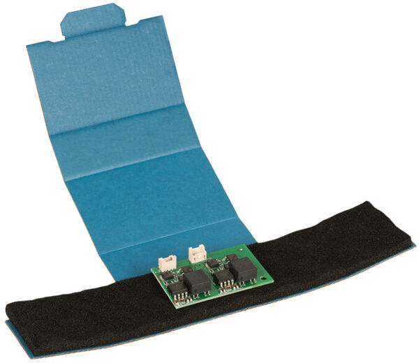 The image shows an open, blue package with a green electronic component in the center. The component has several black chips and two connectors.