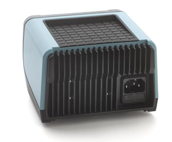 The image shows a compact, rectangular electrical device with a matte, light blue front and a cooling air grille made of black painted metal on the back.