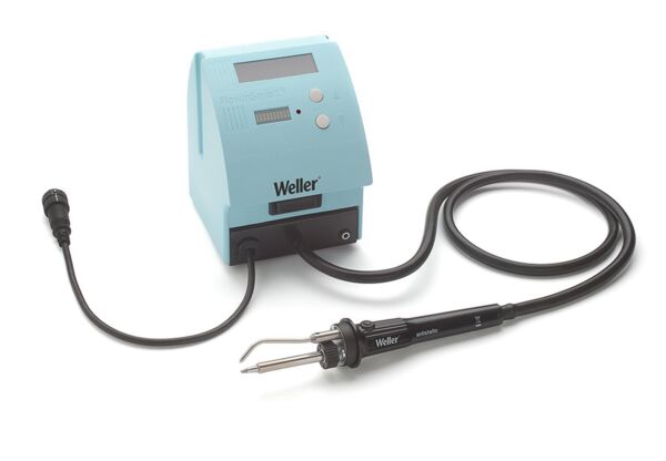 The image shows a blue soldering station with a digital display and several buttons. A long cable leads to a soldering iron with a pointed tip, which is lying on a table.