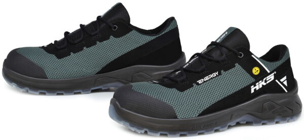 The image shows a pair of athletic shoes in black and gray. They have a padded sole and a breathable upper with laces. The design appears sturdy and functional.