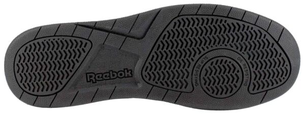 The image displays the black sole of a Reebok shoe. It features a non-slip tread with various patterns, including waves and diagonal grooves, for improved traction.