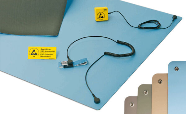 The image displays a blue ESD protection mat with a yellow warning sign. A cable with a grounding clip and a clamp is connected. Color variants of the mat are also visible.