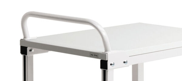 The image shows a white, metal table with a smooth surface. On one side, there is a curved handle bar. The table legs are sturdy and also made of metal.