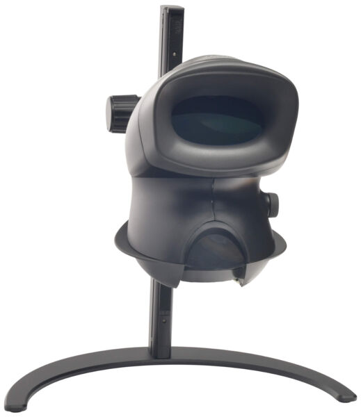 The image shows a black optical device on a stable stand. It has a round opening at the front and a side button. It is designed to be compact and slim.