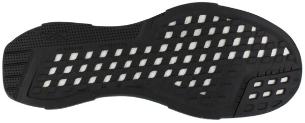 The image shows the sole of a sports shoe. It is predominantly black with a pattern of small grooves and openings that provide slip resistance and flexibility.