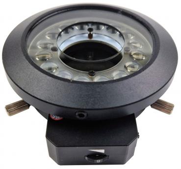 The image shows a round, black device with a glass lens and several small light sources. It has two rotary knobs on the side for adjustments and is mounted on a stable base.