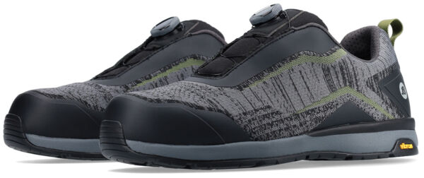 The image displays a pair of stylish, athletic shoes. They are primarily black with gray and green accents, and feature a non-slip sole. They have a modern closure system.