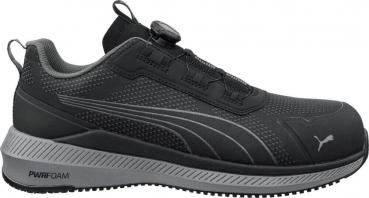 The image shows a black Puma sports shoe with a slightly textured surface. It features a practical lacing system and a flexible, non-slip sole.