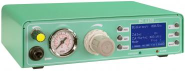 The image shows a green device with a digital display. It has a large dial, a pressure gauge, and several buttons and indicators for setting dosing times and mode.