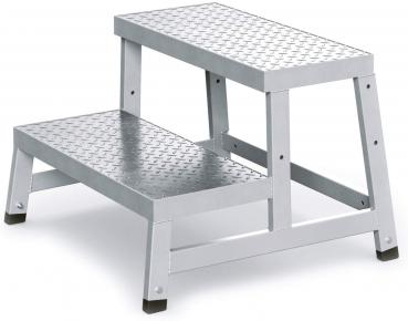 The image shows a silver, two-step metal stepladder. The surfaces are non-slip, and the ladder has a stable, rectangular shape with two steps.