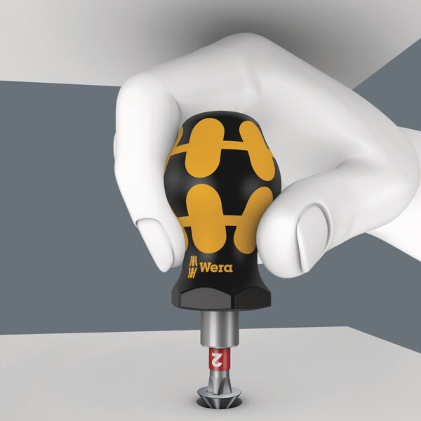 The image depicts a stylized hand holding a screwdriver with an ergonomic handle. The handle is black with yellow patterns, while the tip is inserted into a screw.