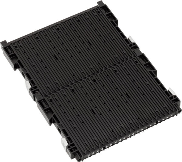 The image shows a black, rectangular component with many parallel grooves. It has small brackets at the corners. The surface is smooth and appears to be made of plastic.