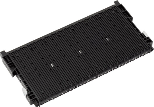 The image displays a rectangular, black component with many narrow, parallel grooves. On the sides, there are small holders or connectors. It has a flat shape and a textured surface.