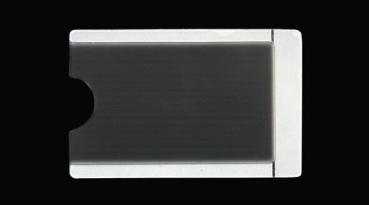 The image shows a flat, rectangular card with rounded corners. The surface is smooth and dark, with a recess on the left side. The background is black.