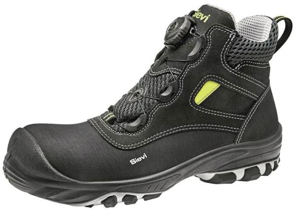 The shoe is a black, sturdy half-shoe with a reinforced toe cap. It features a quick lacing system and a grippy sole. A yellow logo and padded trim are visible.