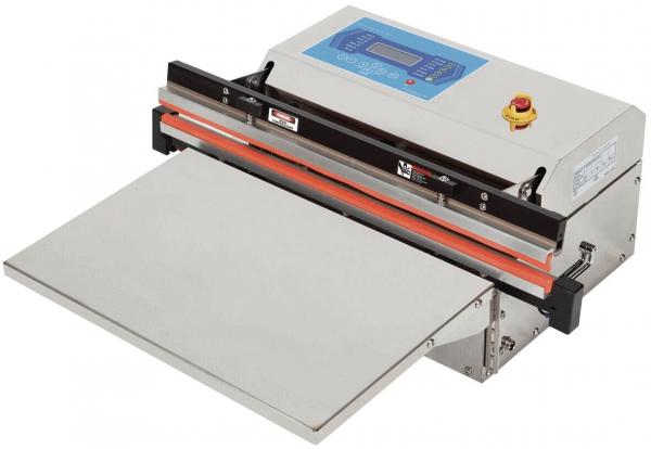 The image shows an electric vacuum packaging machine. It has a rectangular work surface, digital controls on the top, and a large, flat lid.