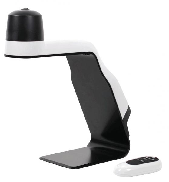 The image shows a modern table lamp in black and white. It has a creative, curved shape and a round top. Next to the lamp is a small remote control.