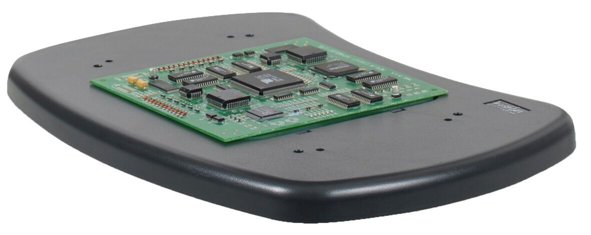 It is a black, flat platform with a green circuit board (PCB) in the center. On the board, there are several black and silver components, such as chips and resistors, arranged.