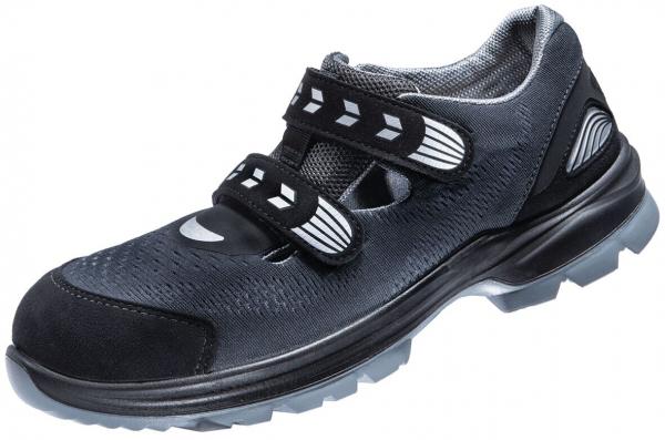 The shoe is black with a sporty design. It has two Velcro straps and a textured surface. The sole is stable and slip-resistant, ideal for active use.