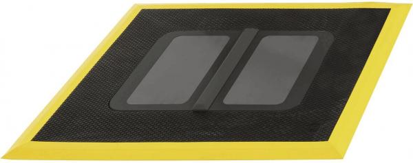 The image shows a rectangular mat with a yellow border. In the center, there are two rectangular black areas that have a textured surface.