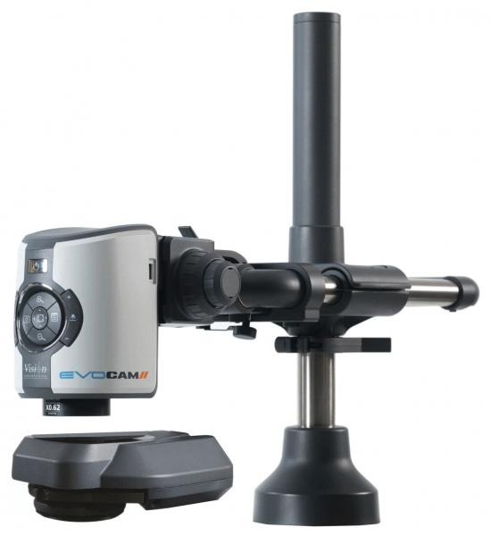 The image shows a microscope with a camera. It has a compact, gray and black design, with a round lens stage and a long, vertical stand.